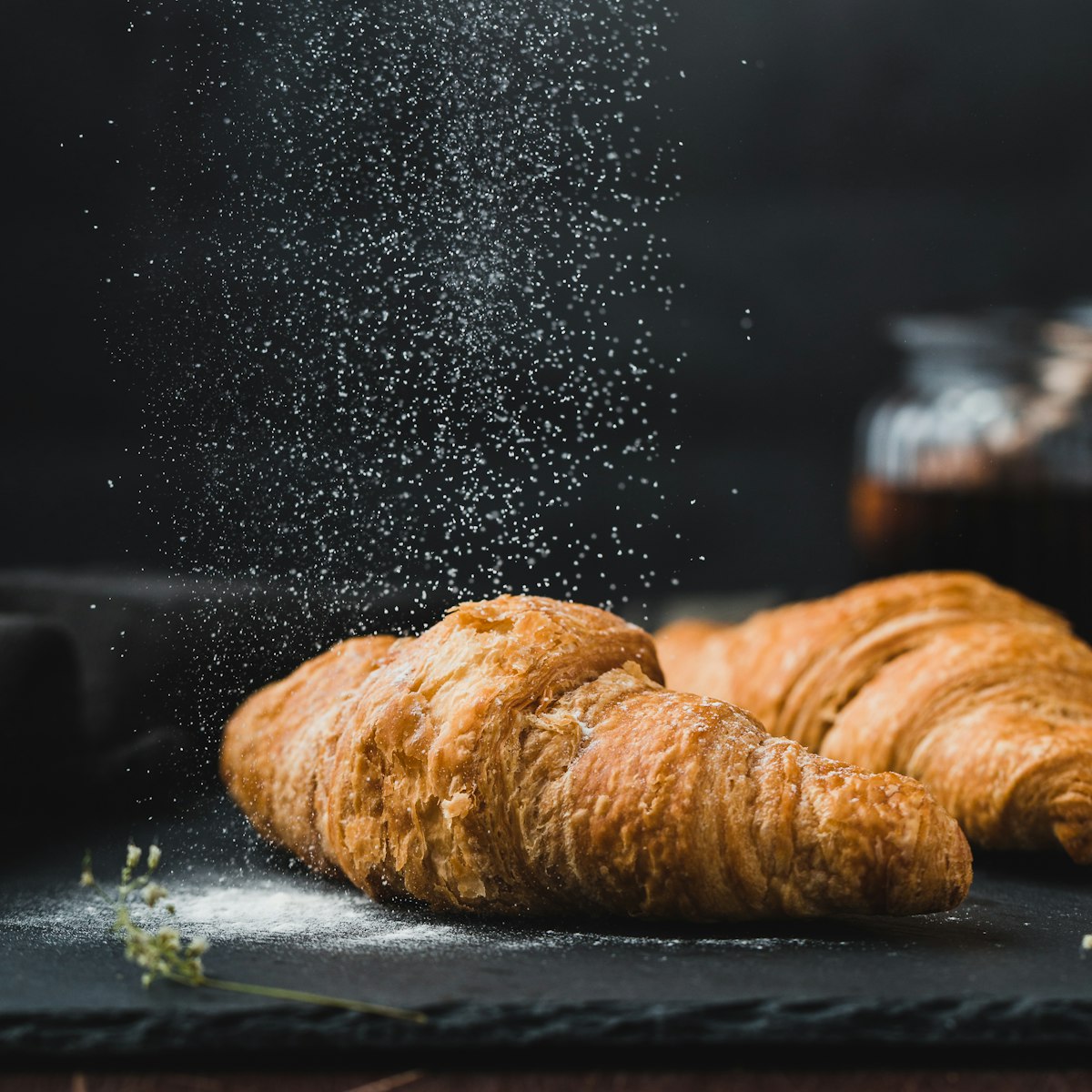 Freshly baked croissants dusted with icing sugar